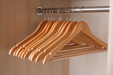 Set of clothes hangers on wardrobe rail