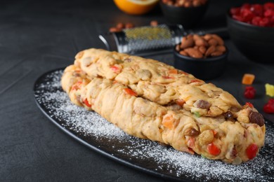 Unbaked Stollen with candied fruits and raisins on grey table, closeup