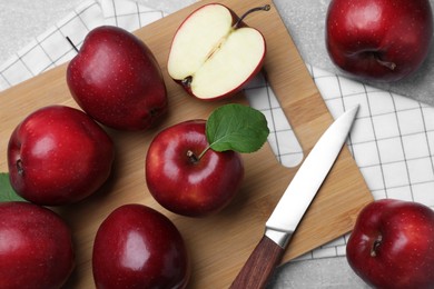 Photo of Fresh ripe red apples and knife on light grey table, flat lay