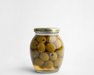 Glass jar with pickled olives on white background