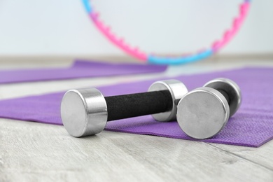 Dumbbells on fitness mat in physiotherapy gym, closeup