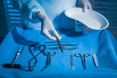 Professional surgeon with instruments in clinic, closeup