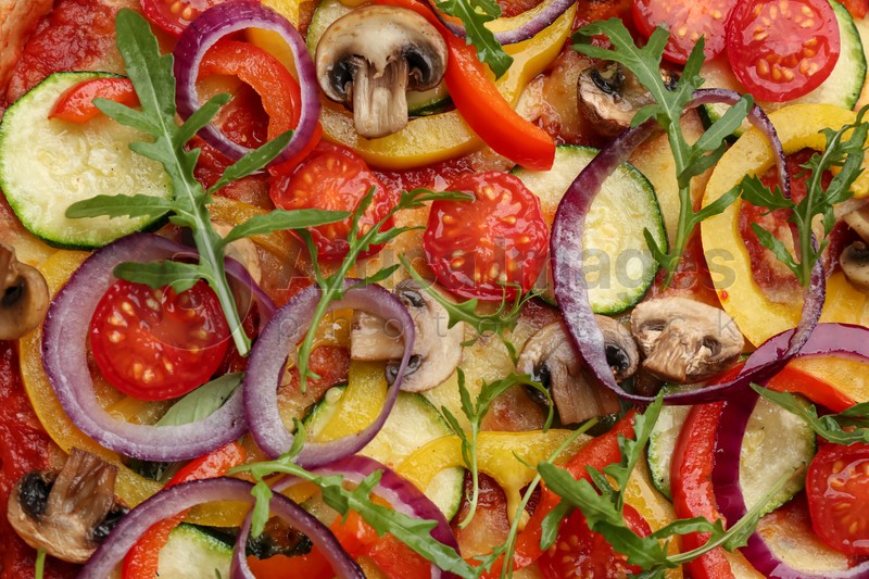Photo of Delicious hot vegetable pizza with mushrooms as background, closeup
