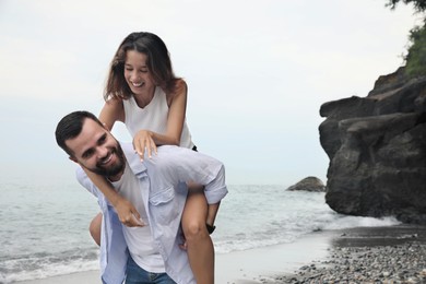 Happy young couple having fun on beach sea. Space for text