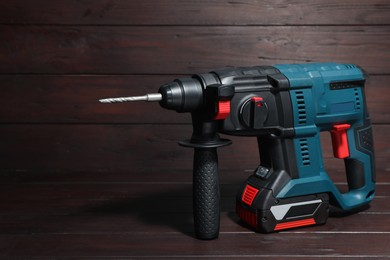 Modern electric power drill on wooden table
