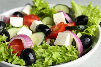 Tasty fresh Greek salad in  bowl, closeup