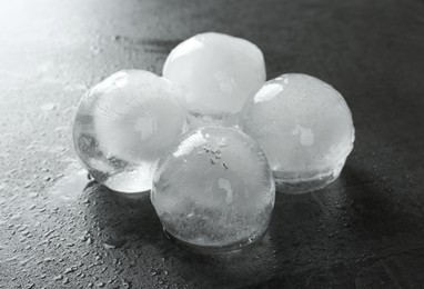 Melting ice balls on dark grey table