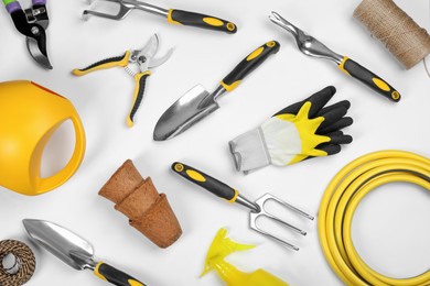 Flat lay composition with gardening tools on white background