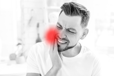 Man suffering from strong toothache at home