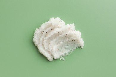 Sample of body scrub on green background, top view