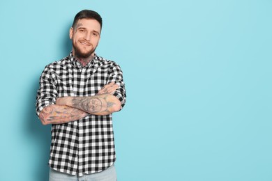 Photo of Portrait of handsome hipster man on light blue background. Space for text