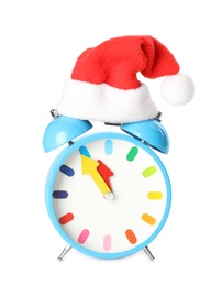 Photo of Alarm clock with Santa hat on white background. New Year countdown