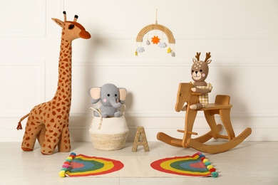 Photo of Composition with cute toys and children's room interior elements indoors