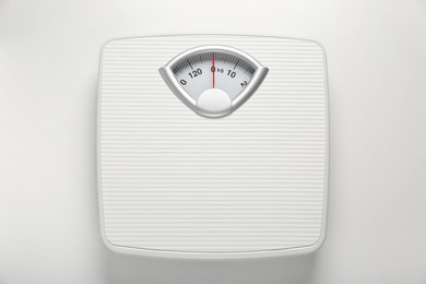Photo of Mechanical scales on white background, top view