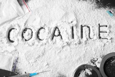 Composition with cocaine powder on black background, top view