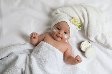 Cute little baby with cream on face, top view