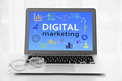 Image of Digital marketing concept. Modern laptop on white background
