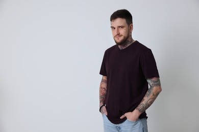 Photo of Portrait of hipster man on light grey background. Space for text