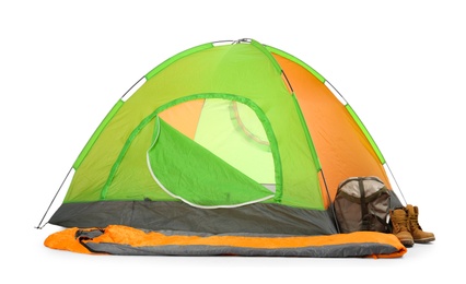 Comfortable colorful camping tent with sleeping bag and boots on white background