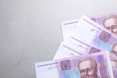 Ukrainian money on grey background, flat lay. Space for text