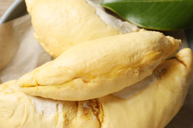 Photo of Pieces of fresh ripe durian on plate, closeup