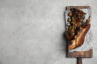 Photo of Delicious roasted ribs served on grey table, top view. Space for text