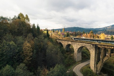 Aerial view of bridge and village on autumn day