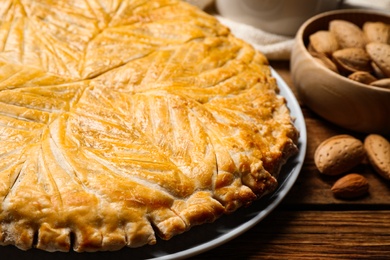 Traditional galette des rois on wooden table, closeup