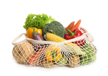 Photo of Fresh vegetables in eco mesh bag on white background