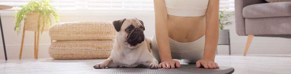 Woman with dog practicing yoga at home. Horizontal banner design 