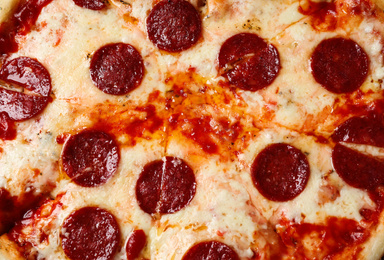 Hot delicious pepperoni pizza with melted cheese, closeup