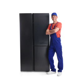 Male technician near refrigerator on white background