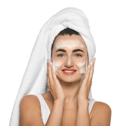 Beautiful woman applying cleansing foam onto face against white background