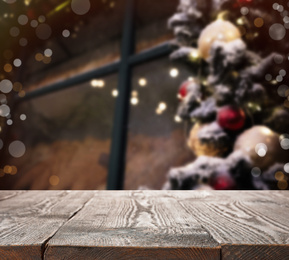 Image of Empty wooden surface and blurred view of Christmas tree