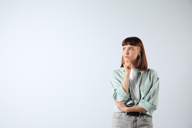 Portrait of confused young girl on white background. Space for text