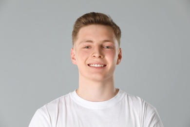 Portrait of teenage boy on light grey background
