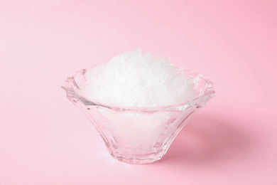 Shaving ice in glass dessert bowl on pink background, closeup