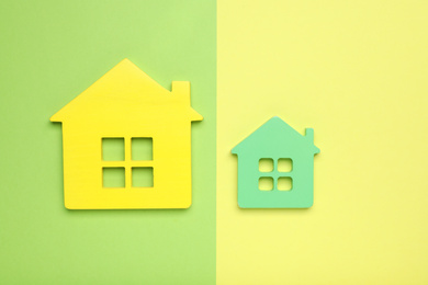 Small and big house figures on color background, flat lay. Pareto principle concept