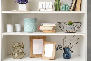 White shelving unit with books and different decorative stuff
