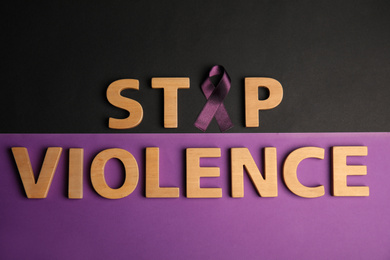 Purple ribbon and phrase STOP VIOLENCE on color background, flat lay