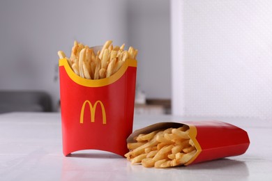 MYKOLAIV, UKRAINE - AUGUST 12, 2021: Two big portions of McDonald's French fries on white table