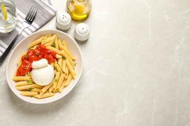 Delicious pasta with burrata cheese and sauce served on light grey table, flat lay. Space for text
