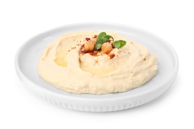 Plate of tasty hummus with garnish isolated on white
