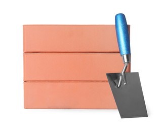 Photo of Red bricks and trowel on white background