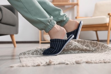 Photo of Man tripping over rug at home, closeup