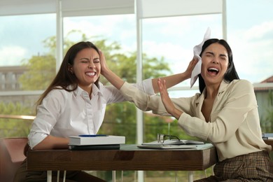 Colleagues fighting at table in office. Workplace conflict