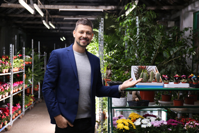 Photo of Male business owner standing in his flower shop