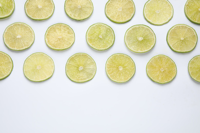 Fresh juicy lime slices on white background, top view