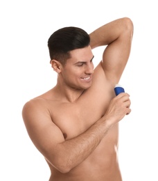 Photo of Handsome man applying deodorant to armpit on white background