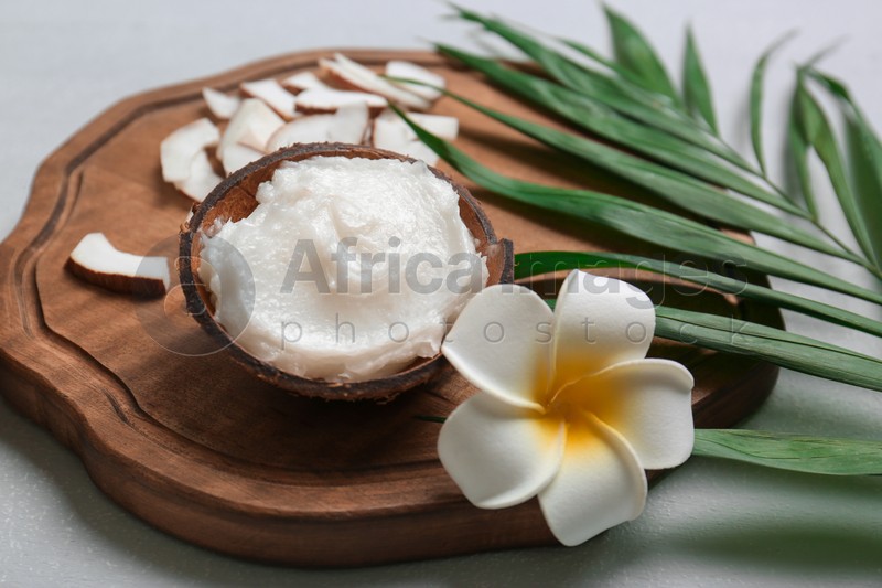 Beautiful composition with coconut oil on wooden board